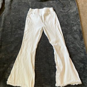 White flare jeans with frayed bottoms